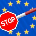 An illustration of a red stop barrier against the backdrop of the European Union flag with yellow stars.