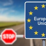 European Union road sign beside a stop barrier on a border crossing road