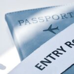 A passport partially covered by a paper strip that reads “ENTRY Refused” in bold letters.