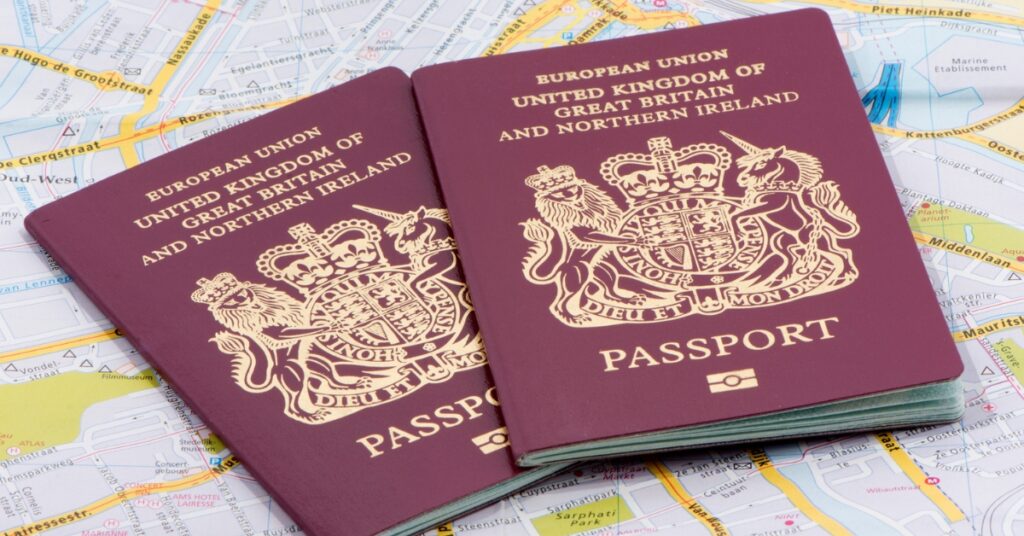Two UK passports rest on a detailed city map, suggesting travel planning or preparation.