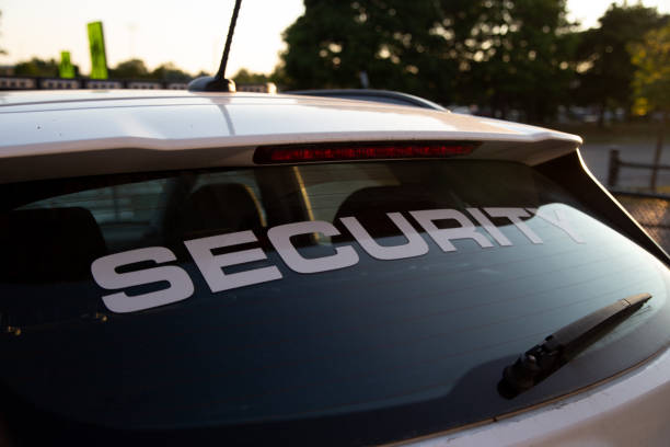 Close-up of a vehicle rear window displaying the word “SECURITY” in large white letters.