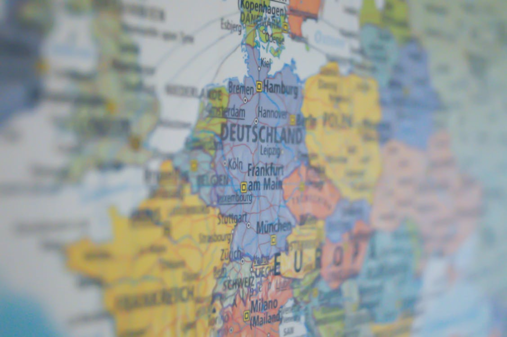 Close-up of a printed map highlighting Germany and nearby European countries, with city names and borders in focus.