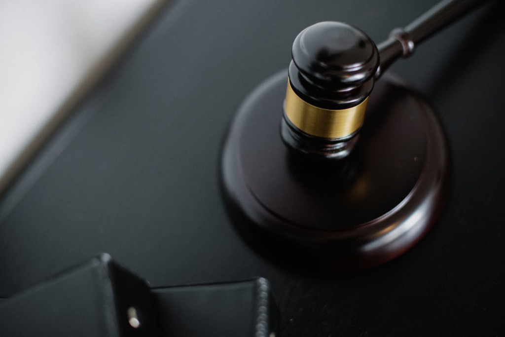 Close-up of a judge’s gavel resting on a dark desk, symbolizing law and justice.