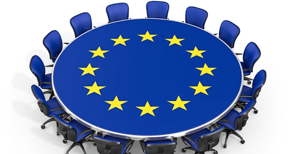 Illustration of a round conference table with the EU flag design and blue chairs arranged around it