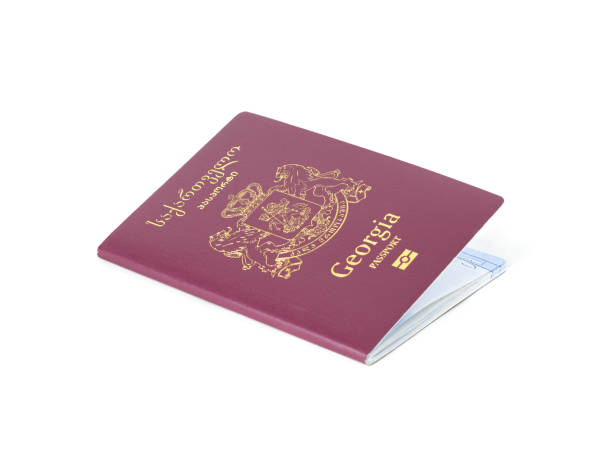 Georgian passport with gold emblem placed on a white background.