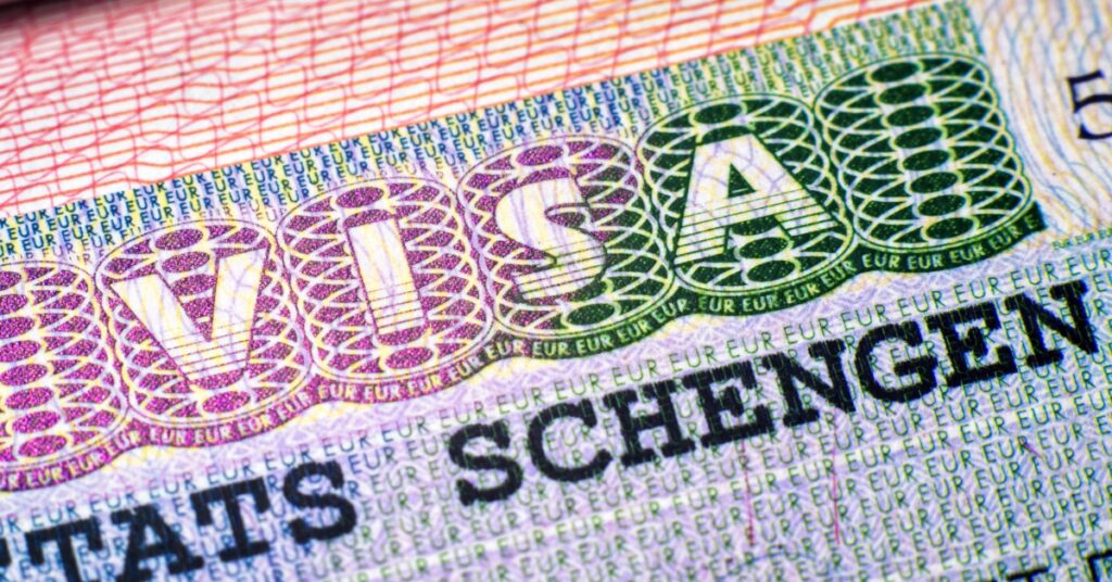 Close-up of a Schengen visa showing security patterns and printed text