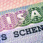 Close-up of a Schengen visa showing security patterns and printed text
