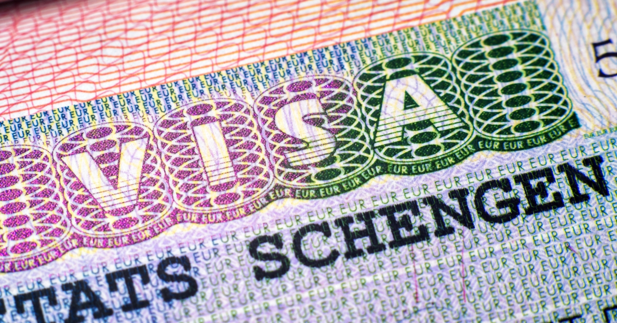 Close-up of a Schengen visa showing security patterns and printed text