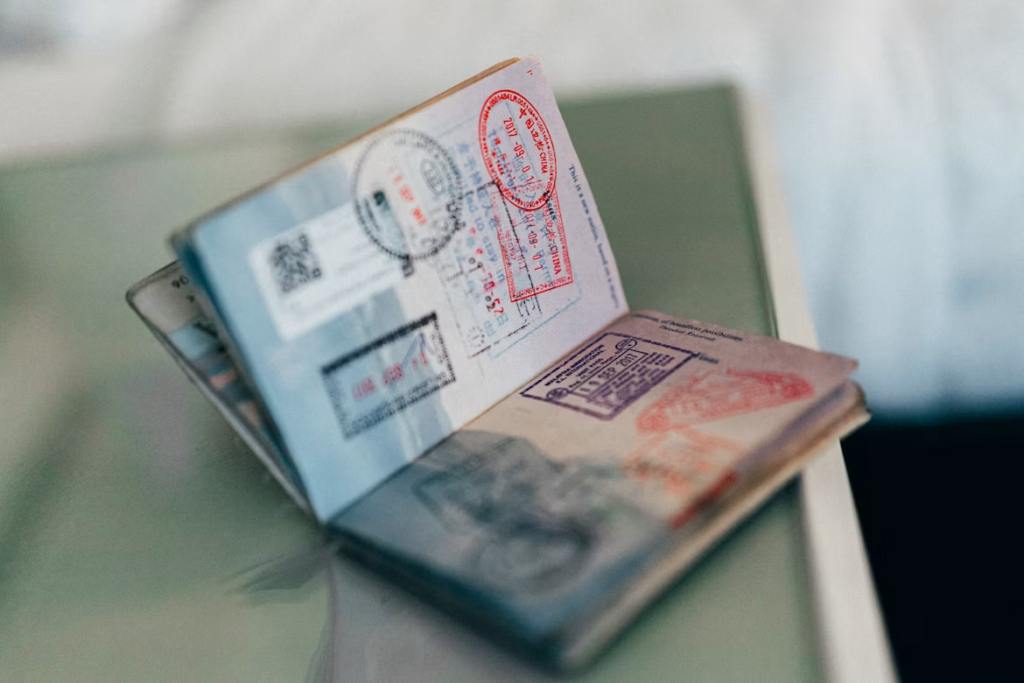 Open passport showing multiple immigration and visa stamps on its pages