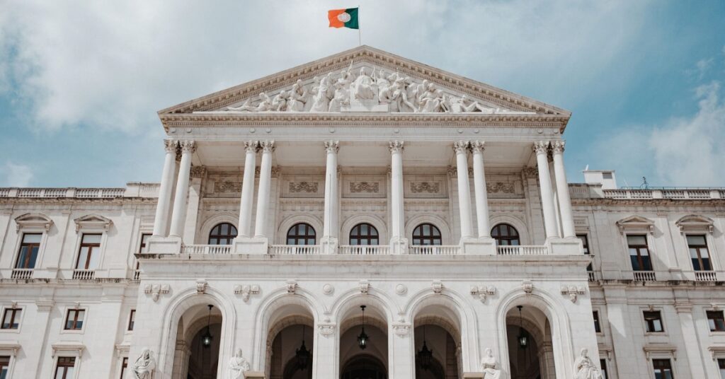 Portugal’s Parliament building in Lisbon, with neoclassical columns, broad steps and the Portuguese flag overhead