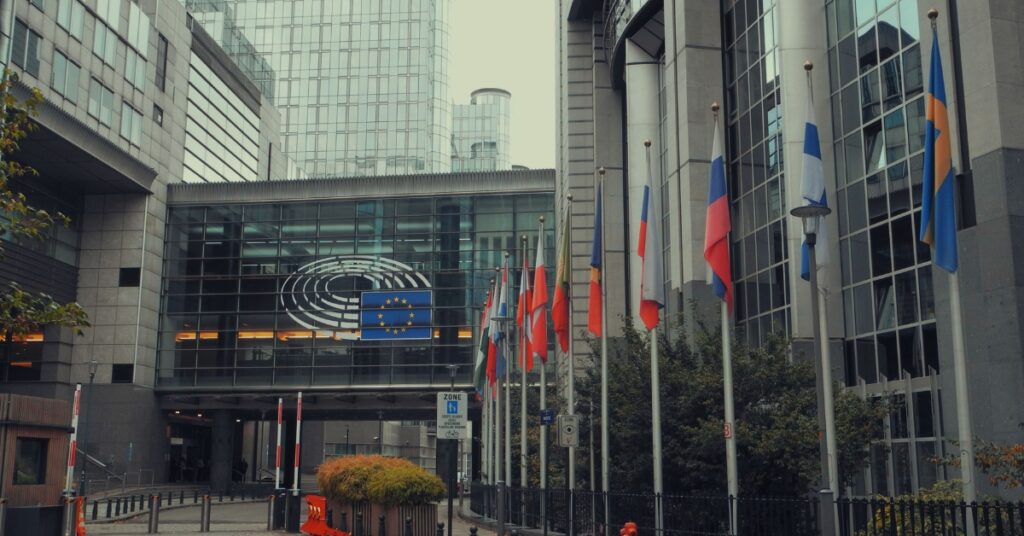 European Parliament building in Brussels with EU and member state flags outside